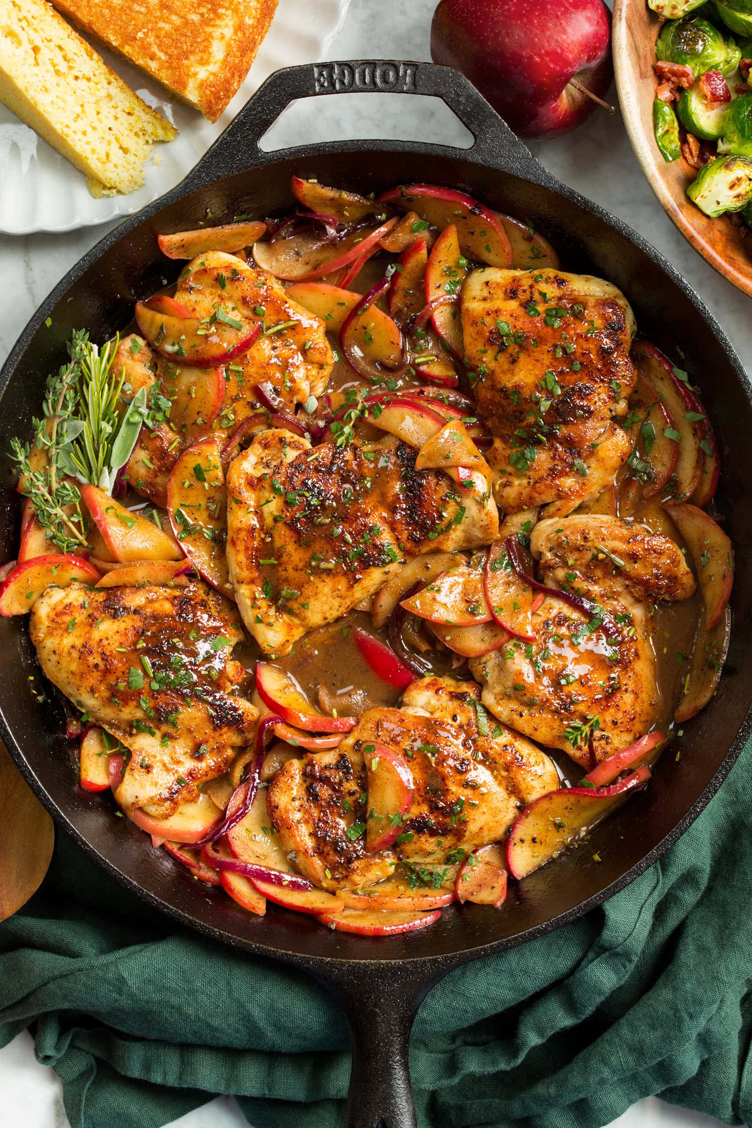 Apple Chicken Apple Chicken in a cast iron pan shown from overhead sitting on a green cloth.