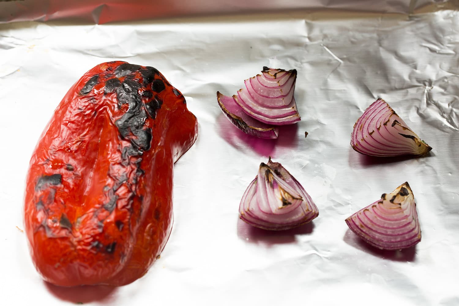 Breakfast Bowls Bell pepper and red onion roasted on foil lined baking sheet.