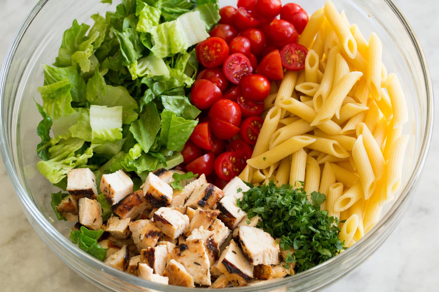 Chicken Caesar Pasta Salad Pasta salad ingredients shown before adding dressing.