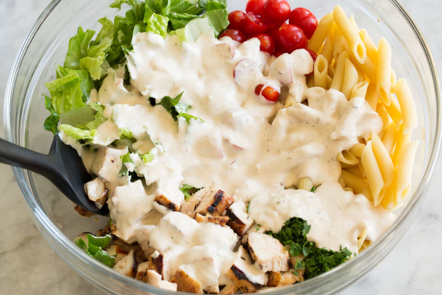 Chicken Caesar Pasta Salad Chicken caesar salad with dressing added.