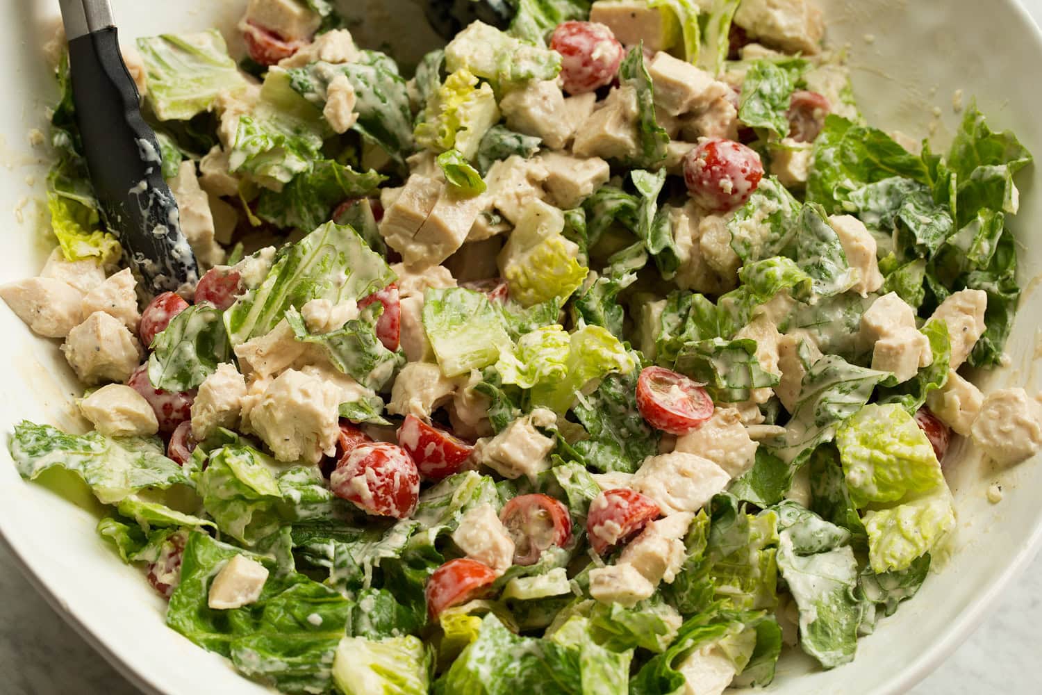 Chicken Caesar Wrap Toss chicken caesar salad and dressing.