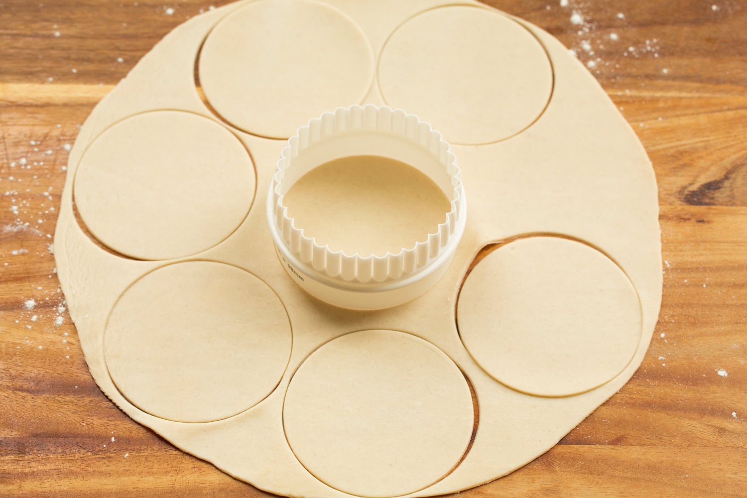 Mini Quiche Cutting pie crust into rounds.