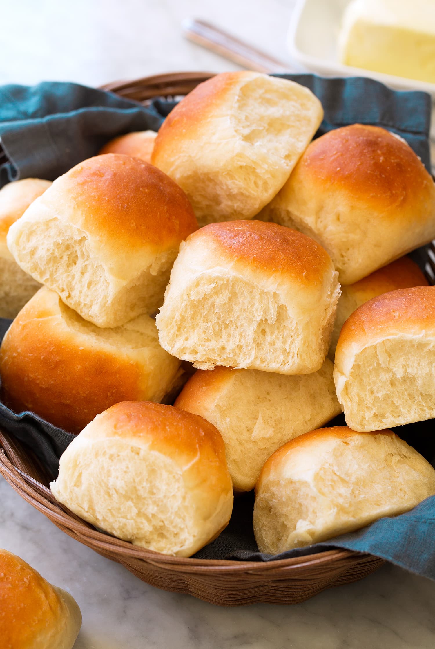 Easy Homemade Dinner Rolls in a bread basket with a blue cloth. Easy Homemade Dinner Rolls in a bread basket with a blue cloth.