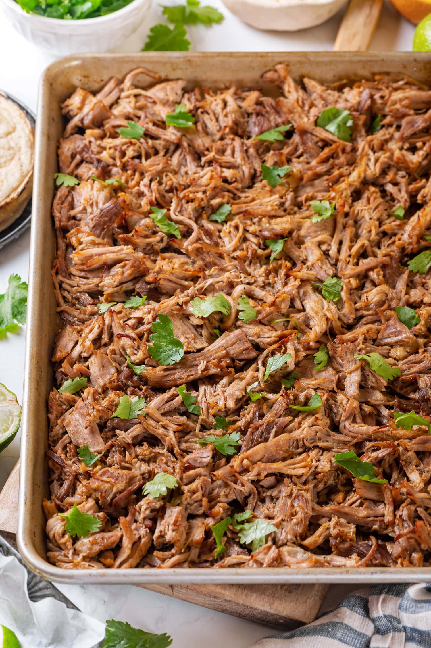 Pork Carnitas Shredded pork carnitas shown on a baking sheet after broiling.