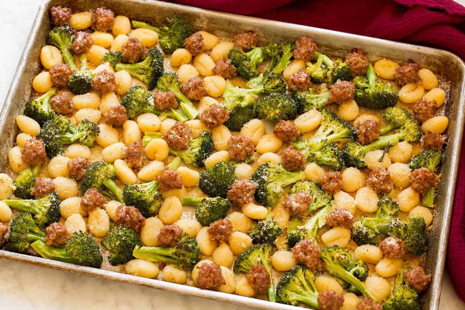 Sheet Pan Gnocchi with Sausage and Broccoli Completed gnocchi, sausage and broccoli shown after baking in oven.