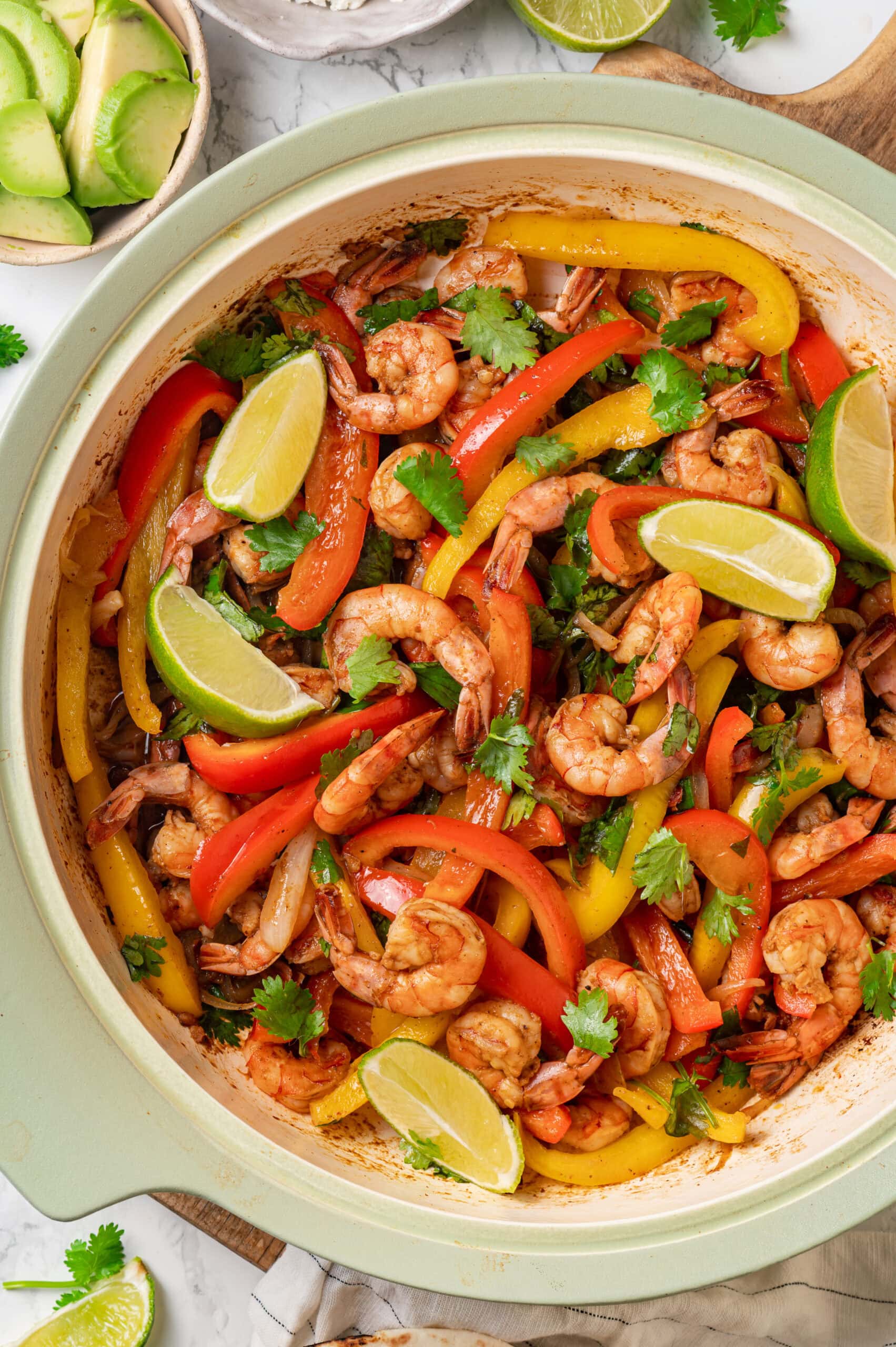 Shrimp Fajitas Completed shrimp fajita mixture shown in a skillet overhead with limes.