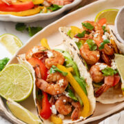 Shrimp fajitas with peppers, avocado, queso fresco and lime.