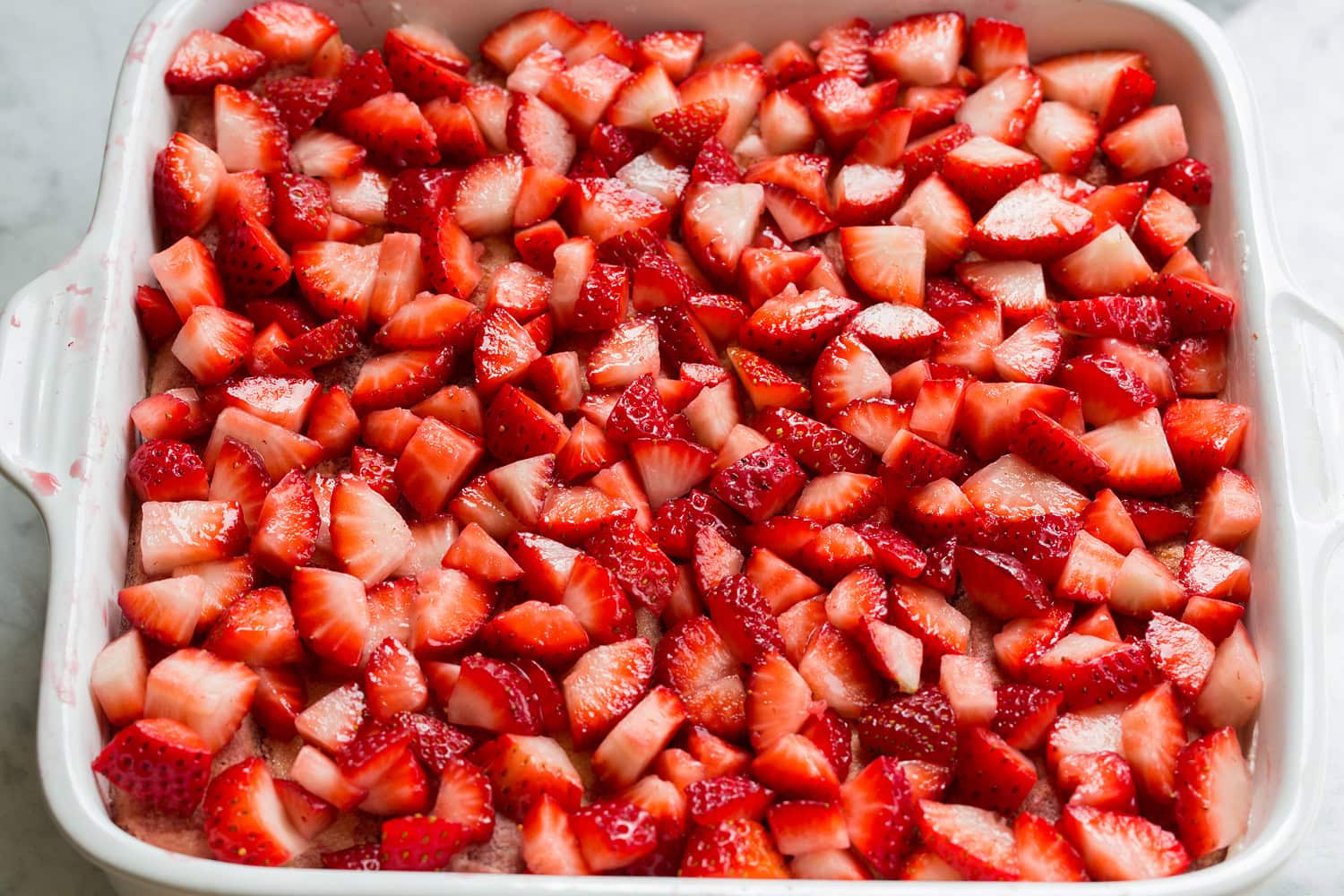 Strawberry Cheesecake Tiramisu Diced strawberries layered in to baking dish over lady fingers