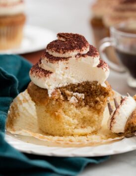 Tiramisu Cupcakes cut into showing interior with soft moist crumb and two flavors.