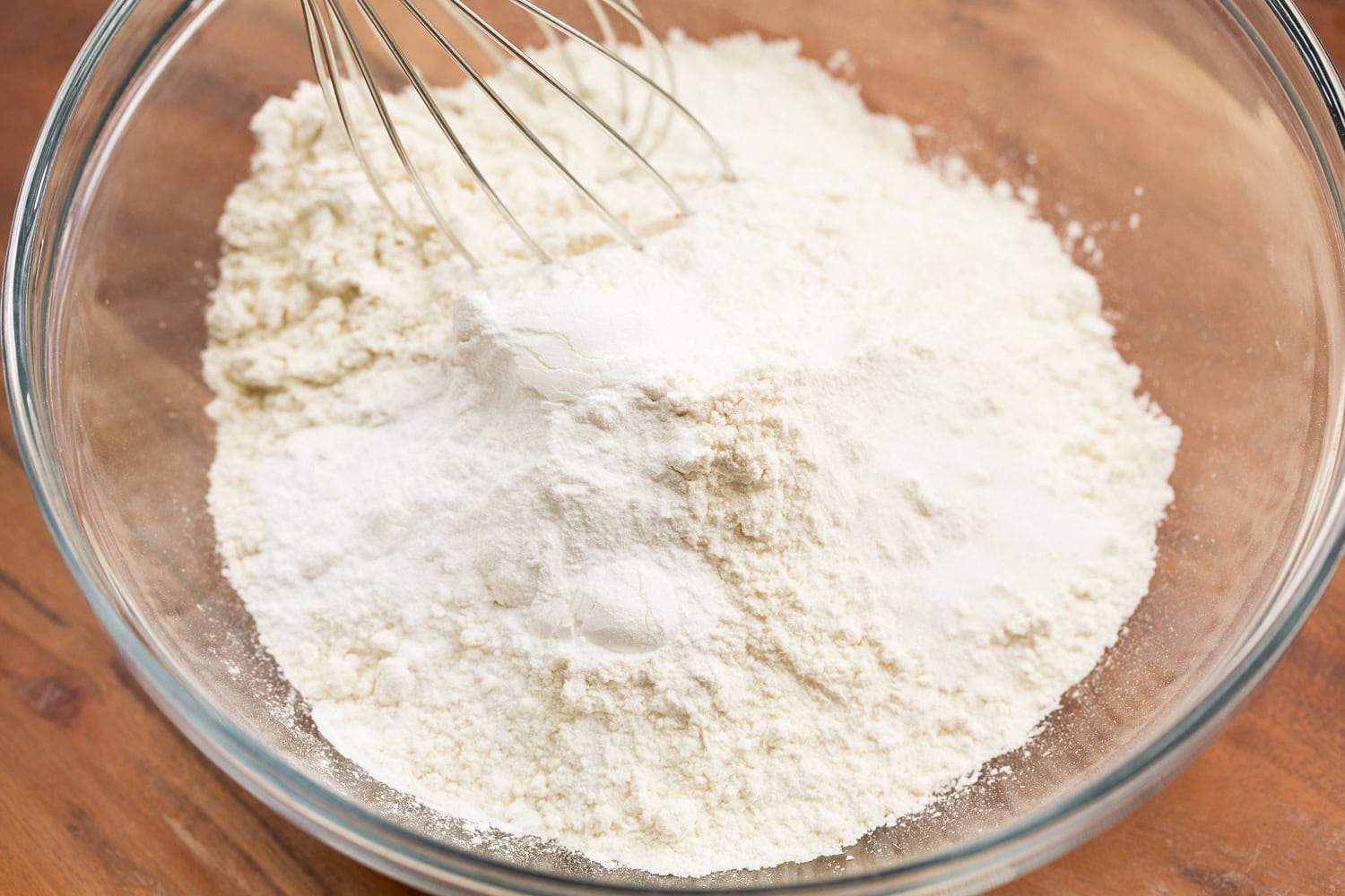 Tiramisu Cupcakes Whisking dry mixture for cupcakes in glass bowl.