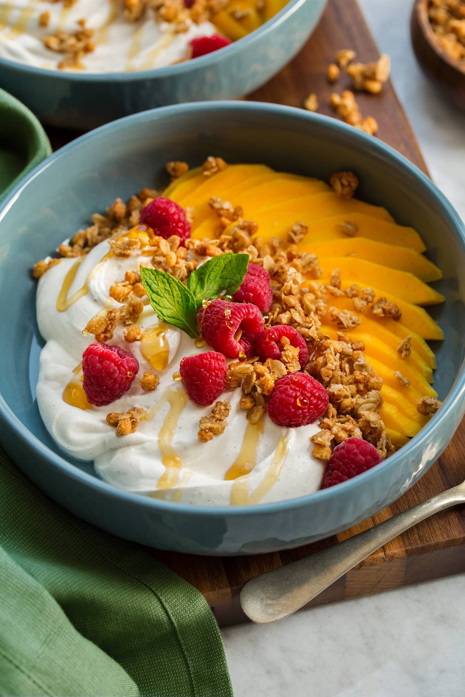 Whipped Yogurt Whipped yogurt shown with honey drizzled over, fruit and granola on the side.