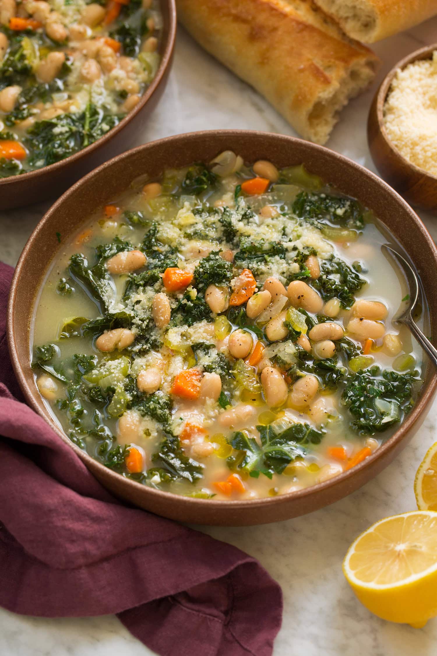White Bean and Kale Soup Serving of white bean and kale soup in a brown bowl.